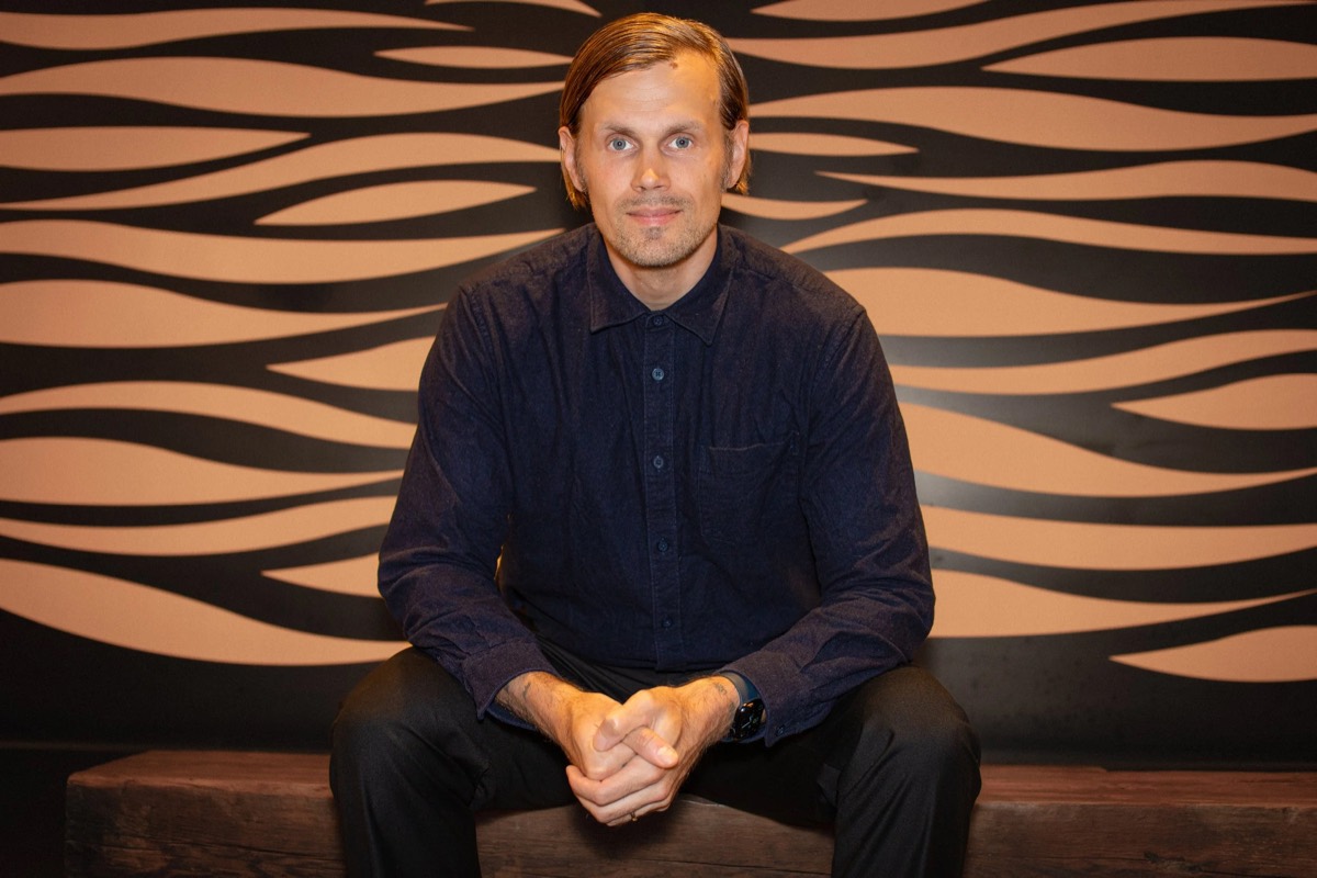 Tommi Forsstrom, smiling in a modern office lounge